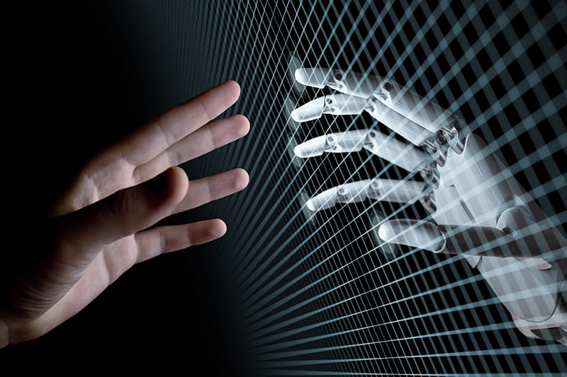 Eine menschliche und eine Roboterhand symbolisieren Künstliche Intelligenz.
